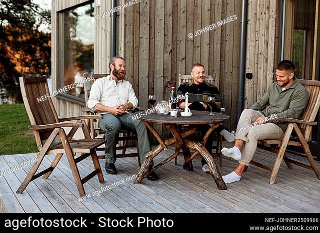 Male friends sitting on patio