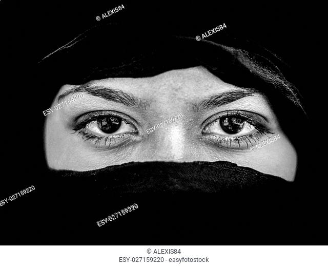 Portrait of beautiful Arab woman wearing black scarf in black and white