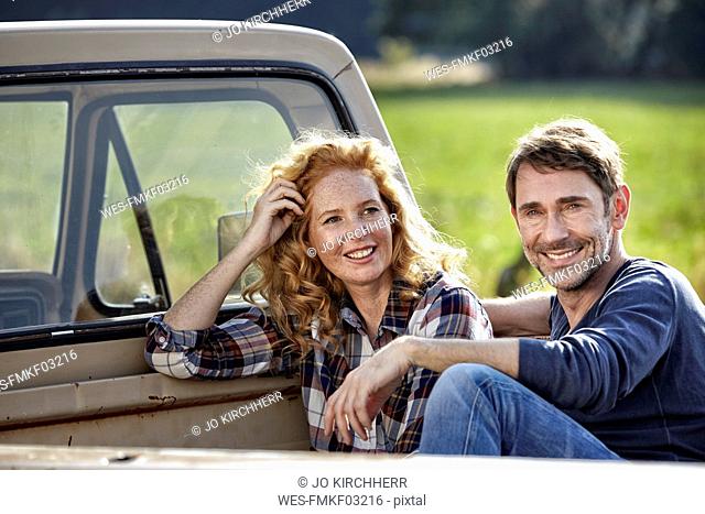 Couple sitting on pick up truck