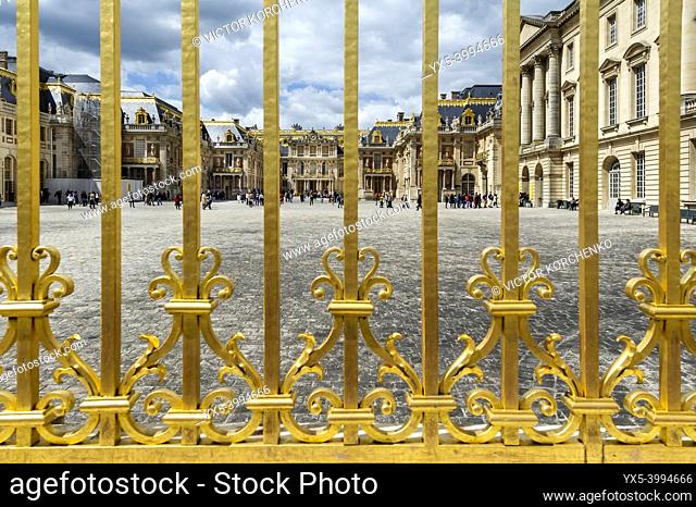 Gilded fence of Versailles Palace shining in the midday sun