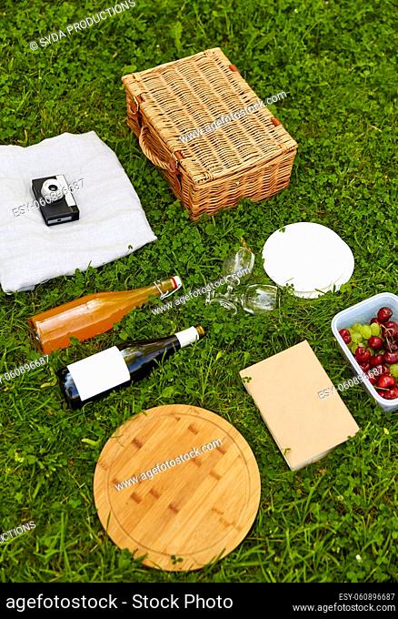food, drinks and picnic basket on grass