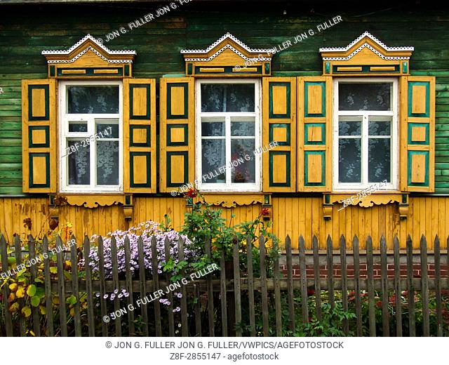 A traditional Russian house, made of wood or timbers and with nalichniki, fancy decorative wood trim, around the windows