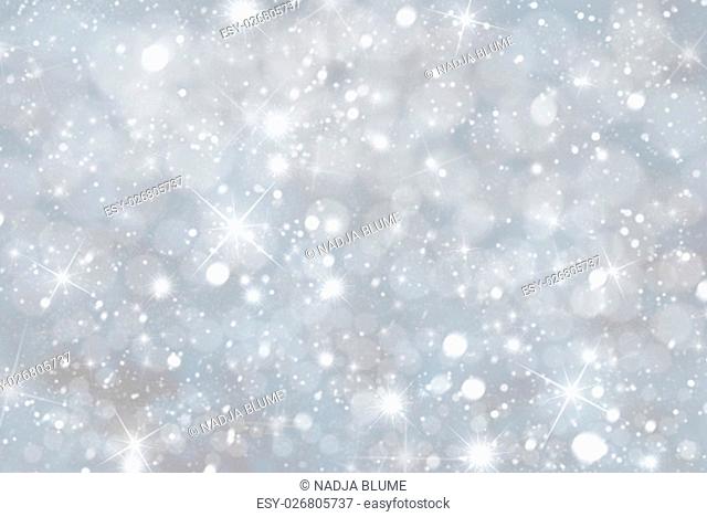 Christmas Texture With Sparkling Stars. Snowflakes With Silver And Blue Colored Background. Card For Seasons Greetings. Magic Bokeh Effect With Lights
