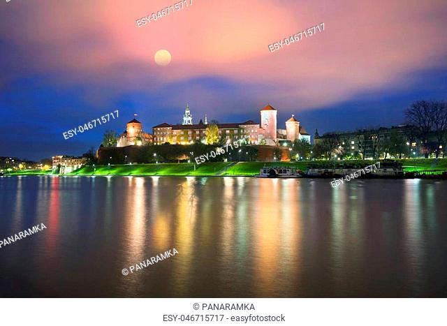 Walk on a rainy evening in the old picturesque embankment of the famous city of Krakow Eastern Europe under the castle of Wawel located on the background wide...