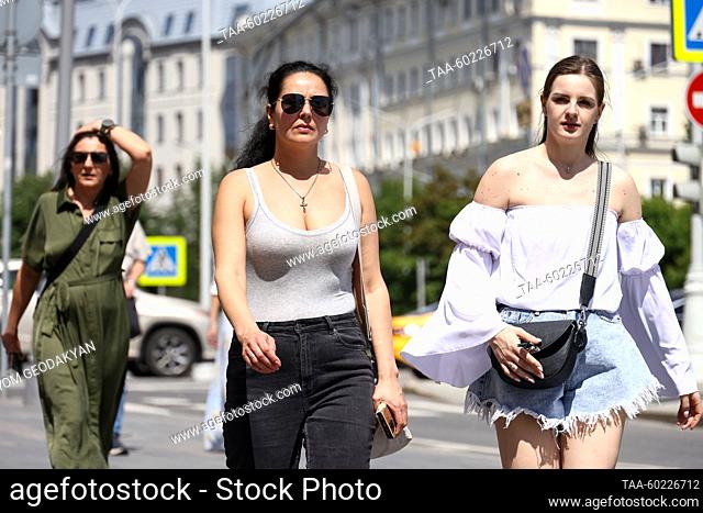 RUSSIA, MOSCOW - JULY 3, 2023: Young women walk in Nikitsky Boulevard Street in summer. Artyom Geodakyan/TASS