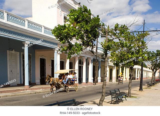 A horse and carriage going past row of columns in the Paseo del Prado, the main avenue, Cienfuegos, Cuba, West Indies, Central America