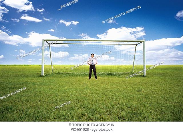 Korean Businessman Defensing at the Goal Post