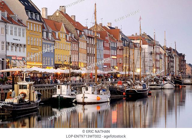 Denmark, Hovedstaden, Copenhagen. Boats and townhouses along the Nyhavn canal in Copenhagen