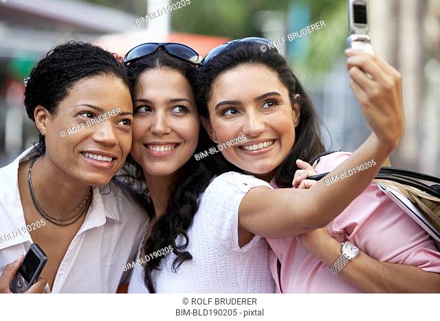 Multi-ethnic friends taking own photograph