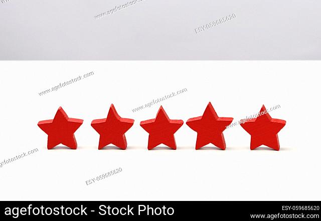wooden five star shape on table. Best excellent business services rating customer experience concept, white table
