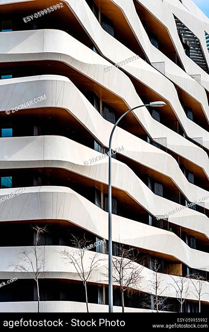 Madrid, Spain - March 7, 2021: New luxury residential building with continuous precast concrete terraces. Mendez Alvaro area