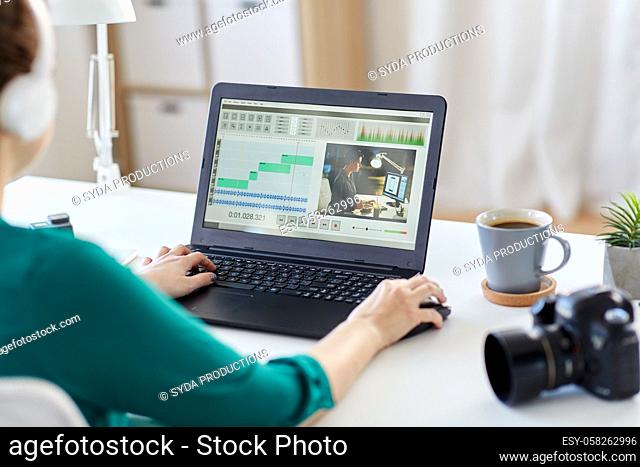 woman with video editor program on laptop at home