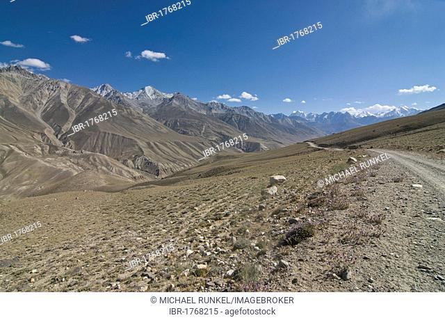 Dirt road leading through mountainous landscape, Wakhan Valley, Pamir Mountains, Tajikistan, Central Asia