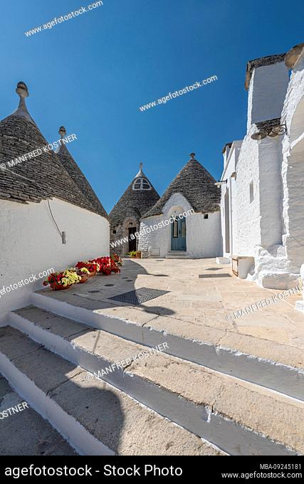 Alberobello, Bari province, Salento, Puglia, Italy, Europe. The typical trulli houses with their cone-shaped roof in the drywall style