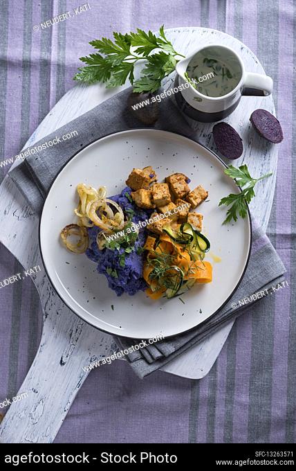 Vegan purple mashed potatoes with zucchini-carrot-vegetables and tofu