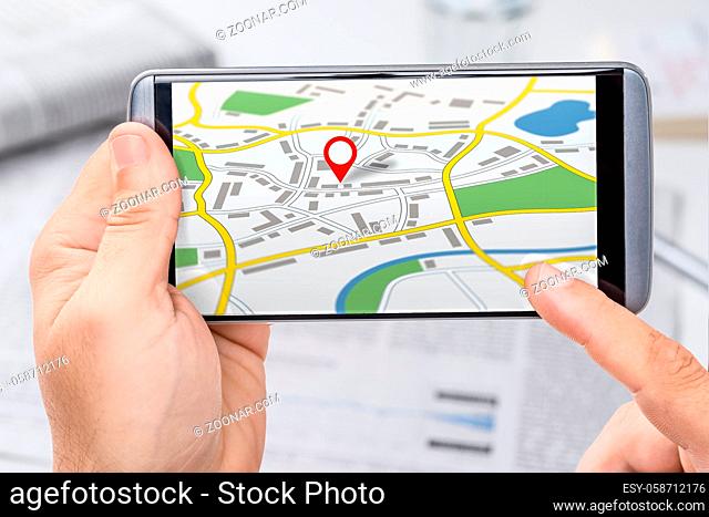 Smartphone with a generic city map with a pin