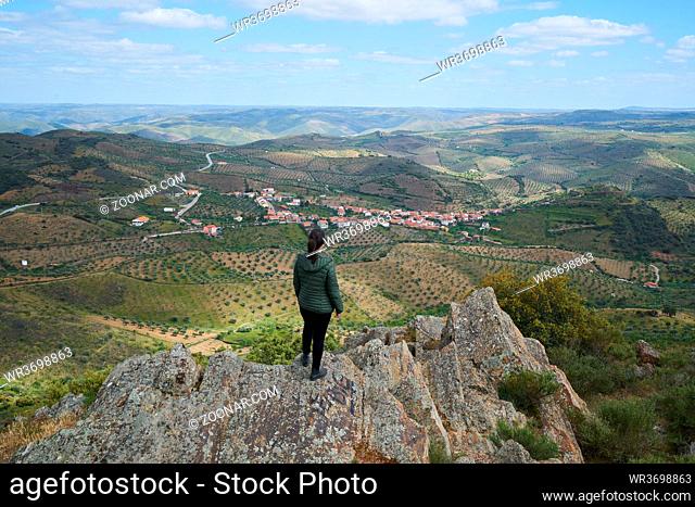 Woman social distancing looking at Castelo Melhor aerial view from miradouro de Sao Gabriel viewpoint