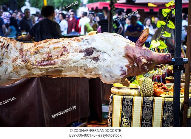 huge grilled pork fact, medieval fair in Spain