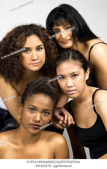Multicultural group of four woman looking straight to the camera