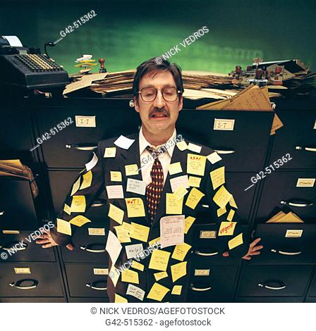 Overworked businessman covered with post-it notes