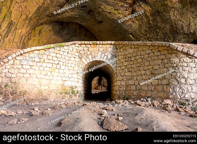 Bulgaria. Old stone walls with arch in Devetaki cave