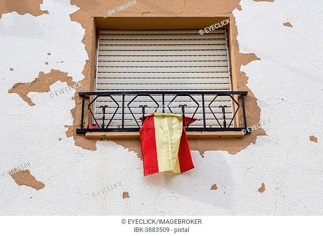 Window with closed blinds and Spanish flag, Humanes, Province of Guadalajara, Spain