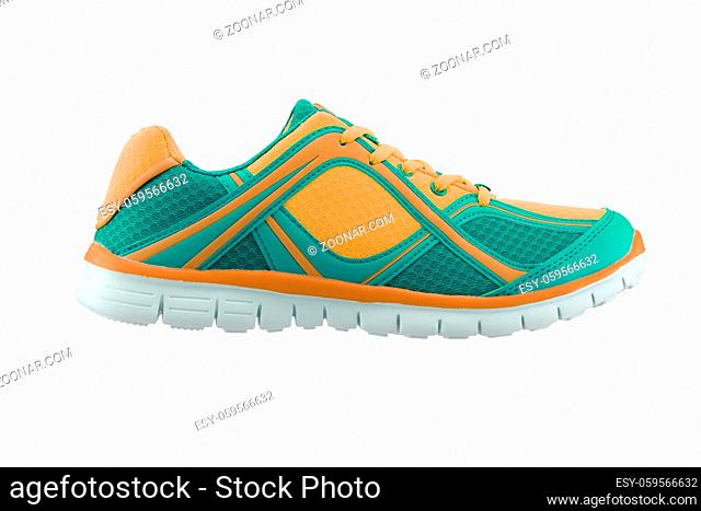 A side view of a green and gold training shoe on white background