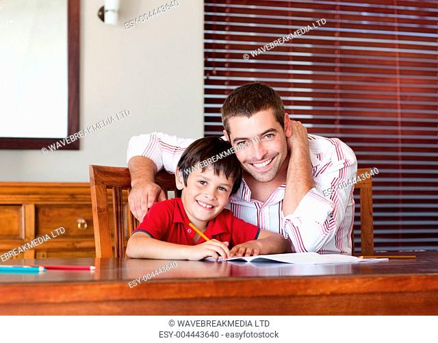 Nice father helping his son for homework