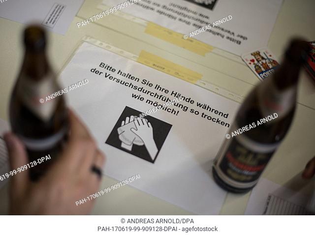 A sheet advises subjects to keep their hands dry in Mainz, Germany, 16 June 2017. The University of Mainz examines the effectivicty of an anti-hangover remedy...