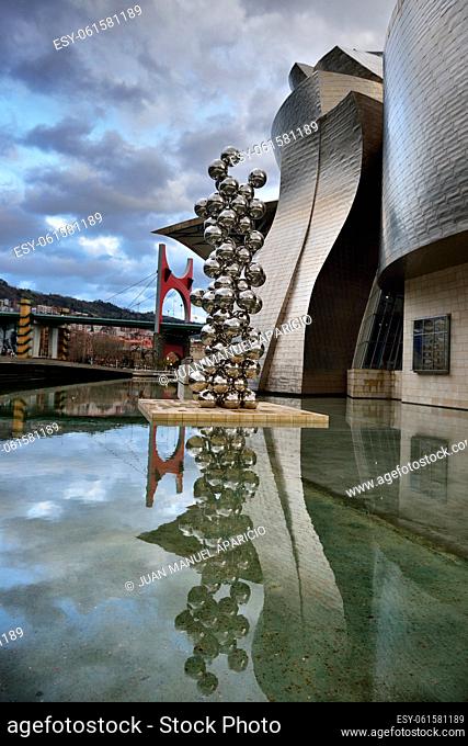The big tree and the eye of Anish Kapoor at the Guggenheim Museum, Bilbao, Biscay, Basque Country, Spain, Euskadi, Spain, Europe