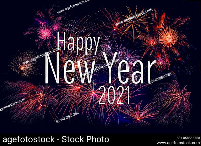 Happy New Year 2021 greeting with colorful fireworks in the night sky