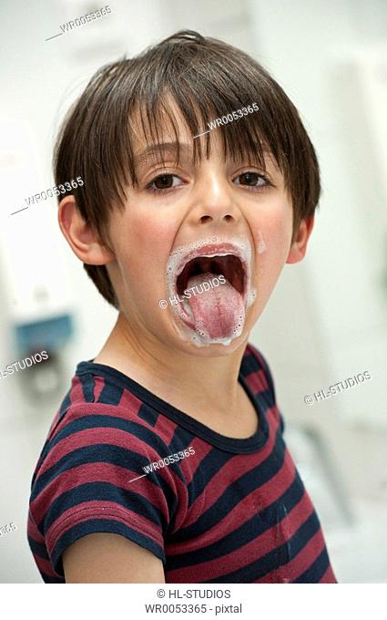 Young boy sticking out his tongue, portrait