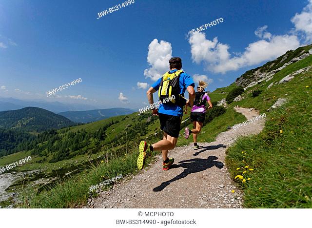 young couple trail running at the Dachstein Mountains, Austria, Styria, Dachstein