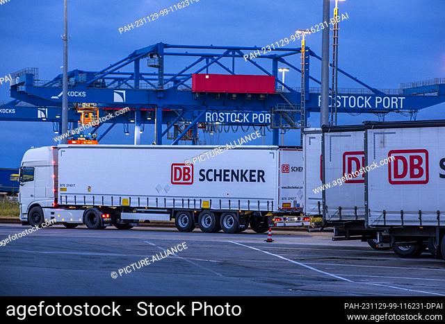 PRODUCTION - 21 November 2023, Mecklenburg-Western Pomerania, Rostock: Trailers from the logistics company DB Schenker are parked on the site of the logistics...