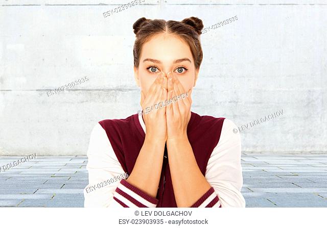people, emotion, expression and teens concept - scared or confused teenage girl over gray urban street background