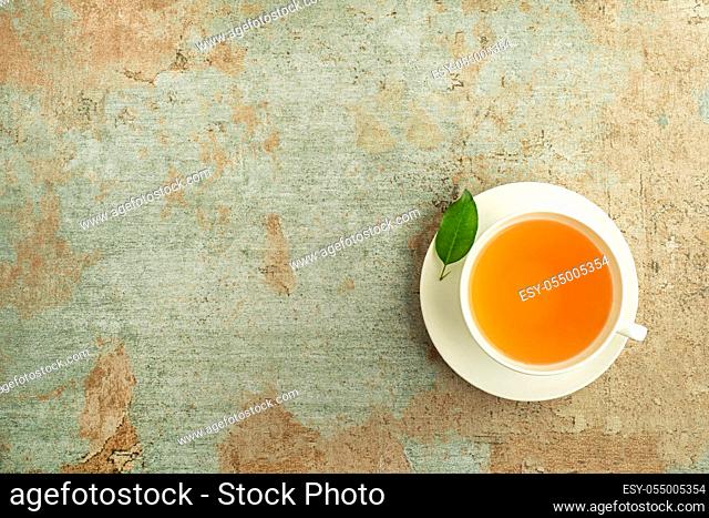 Tea cup. Cup of green and herbs tea served with fresh leaf