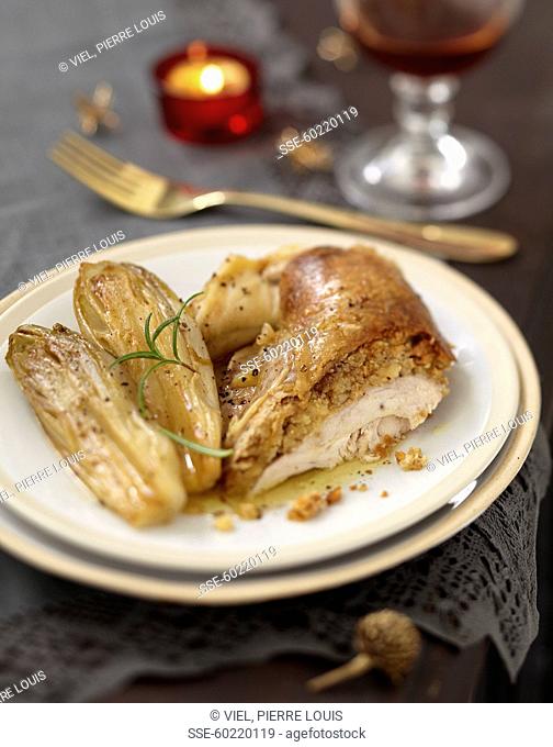 Turkey stuffed under the skin and braised chicory