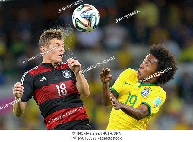 Germany's Toni Kroos (L) and Brazil's Willian vie for the ball during the FIFA World Cup 2014 semi-final soccer match between Brazil and Germany at Estadio...