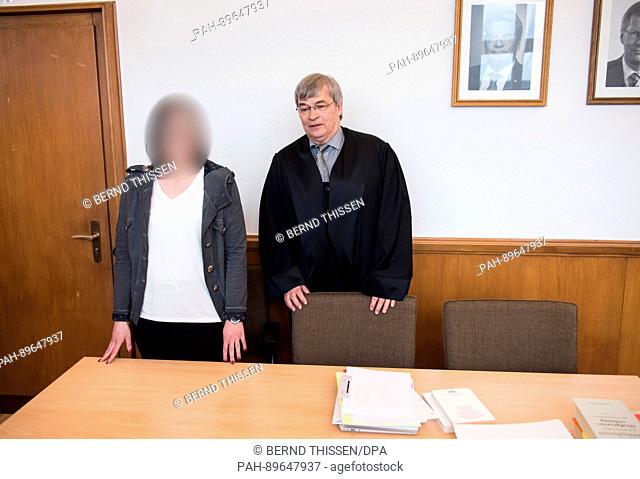 The 28-year-old defendant in a manslaughter case, a youth welfare officer, arrives in court with her defence attorney Thomas Moersberger in Medebach, Germany