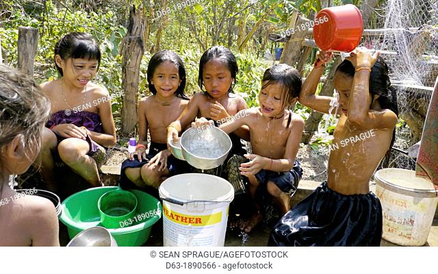 CAMBODIA. Projects of DPA in Stung Treng, supported by SCIAF. Phluck village  Children enjoying themselves washing at the well
