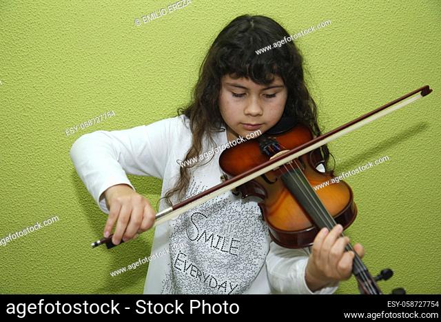 Little girl playing a violin