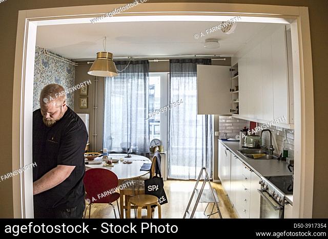 Stockholm, Sweden An electrician fixes wiring in a home