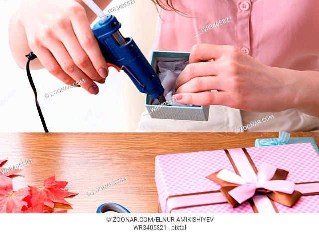 Woman decorating gift box for special occasion