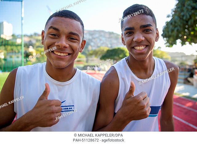 Two students of Brazil's first sports high school, Ginasio Experimental Olimpico (GEO), smile and give a 'thumbs up' in Rio de Janeiro, Brazil, 8 August 2014