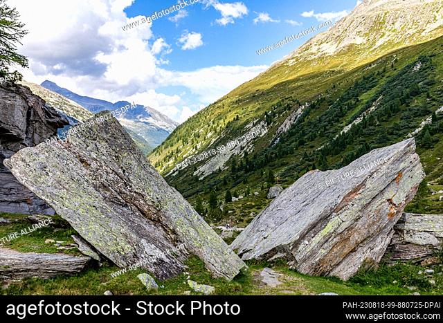17 August 2023, Austria, -: Like the pages of an opened book, boulders lie along a hiking trail between Tyrol (Austria) and South Tyrol (Italy)