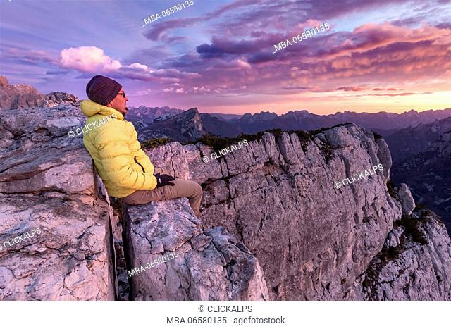 Europe, Italy, Veneto, Belluno, Hiker looking the landscape from Palazza Alta, Civetta group, Dolomites