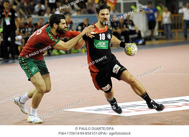 GermanyÂ·s Fabian Wiede, right, challenges PortugalÂ·s Nuno Pereira for the ball during the Euro 2018 Qualification Group 5 handball match between Portugal and...