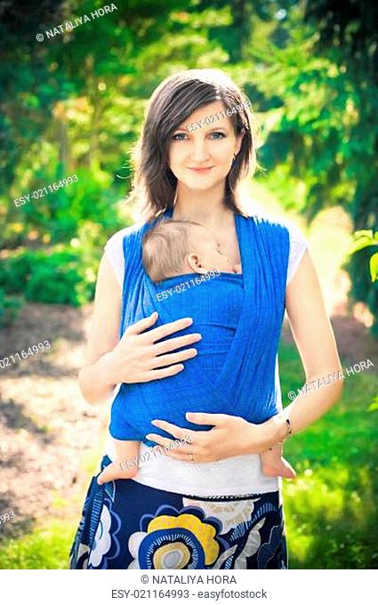 mother with newborn baby in a sling