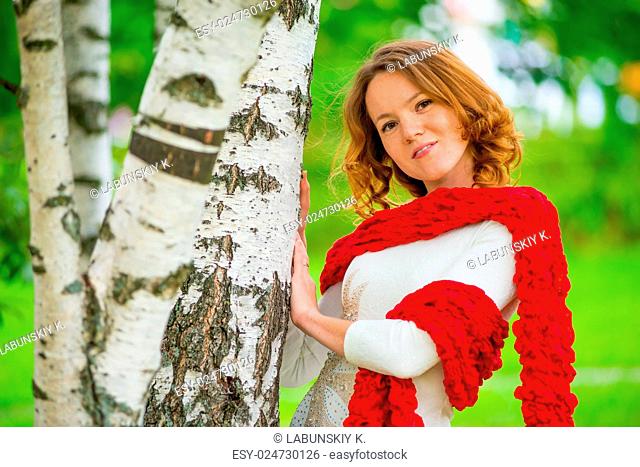 Horizontal portrait of a beautiful girl on nature near the tree