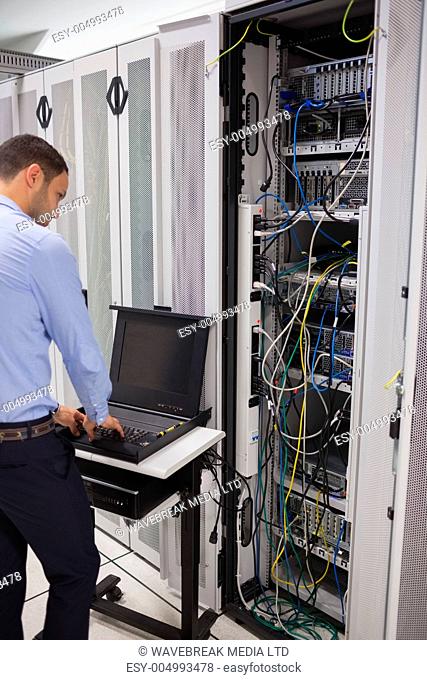 Man repairing servers in data centre